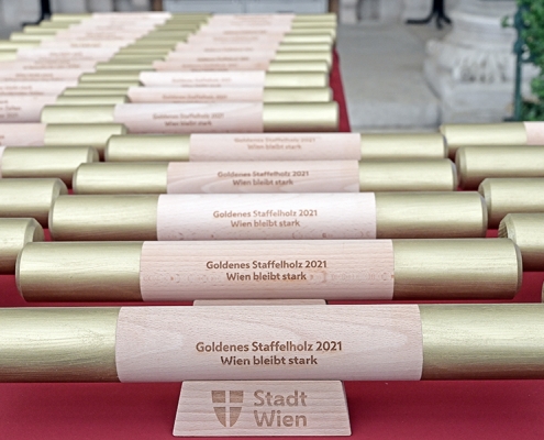 Goldenes Staffelholz 2021 auf Tisch aufgereiht