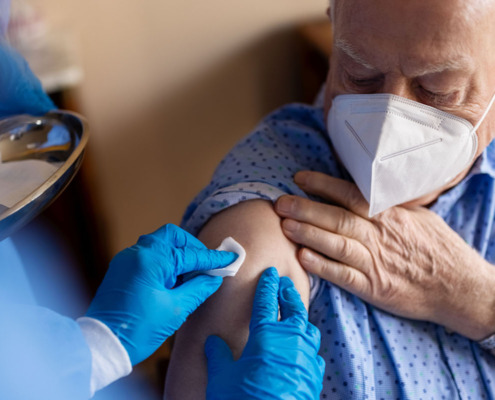 Patient mit FFP Maske bekommt Imfpung